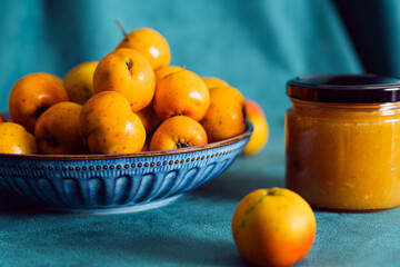 Hawthorn fruits in bowl with homemade jam jar