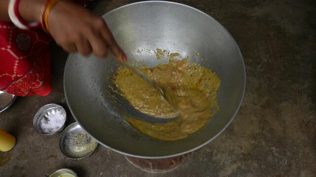 Tomato chutney is being prepared in a pan. Chopped tomatoes are sauteed in oil and spices. This is a popular Indian tomato dish.