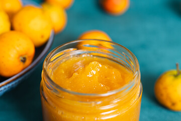 Homemade apricot jam in jar with fresh fruits
