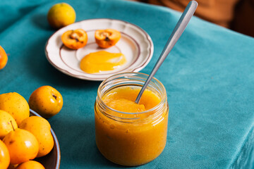 Homemade quince jam in glass jar with fresh fruit
