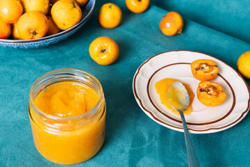 Homemade quince jam on spoon with fresh fruit
