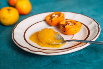 Quince fruit spread on spoon with baked quinces