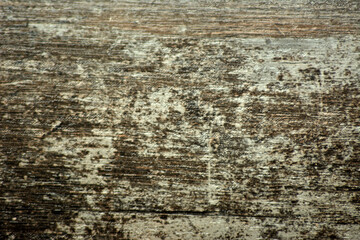Dark wood surface with white aging marks.