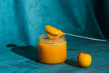 Homemade fruit jam in a jar with spoon