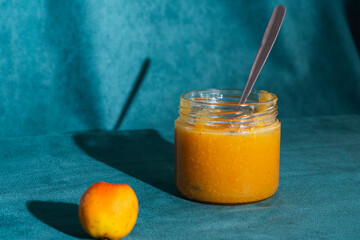 Homemade tejocote jam jar with spoon and fresh fruit