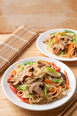 Stir fried noodles with mushroom and vegetables with soy sauce, Asian vegetarian food 