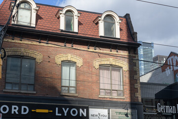 Fototapeta premium exterior of historic building and sign of Nord Lyon, a bakery, located at 665 Queen St W, Toronto