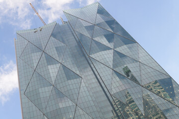 Fototapeta premium north facing elevation of CIBC Square complex, North Towers designed by WilkinsonEyre and Adamson Associates, in neomodern style with diamond-grid pattern on a blue sky in Toronto