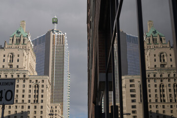Fototapeta premium reflection of Fairmont Royal York, a five-star hotel, on a nearby office tower, looking east on Front St W, Toronto