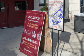 Fototapeta premium sidewalk signs outside Biff's Bistro, a restaurant, located at 2 Front St E, Toronto