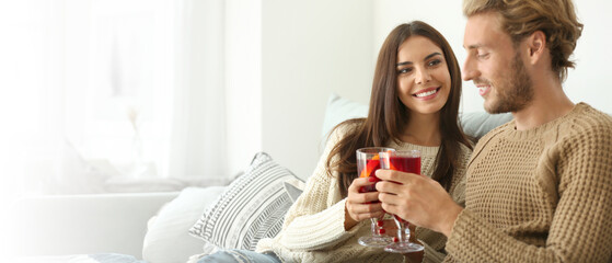 Couple drinking delicious mulled wine at home