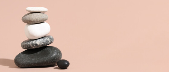 Stack of pebbles on beige background. Zen concept