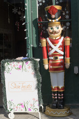 Fototapeta premium toy soldier holiday decorative figure outside Skin Treats, a facial spa, located at 13 Trinity St, The Distillery Historic District, Toronto