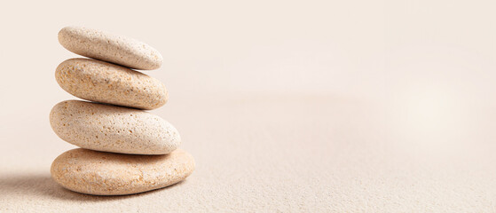 Stack of pebbles on light background with space for text. Zen concept