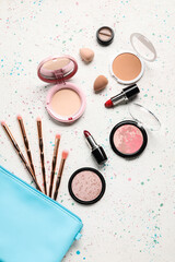 Decorative cosmetics with sponges and brushes on grunge background