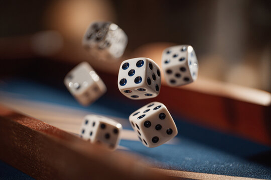 Dice flying through the air during a fun game night with friends in a cozy setting