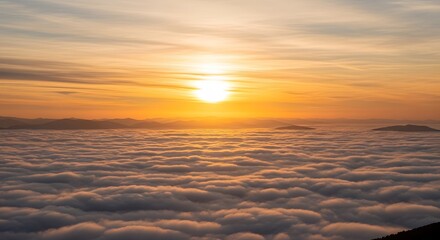 A dramatic sunset scene above a sea of clouds, with the sun casting intense golden and amber tones across the sky. Soft, fluffy cloud layers stretch endlessly, partially revealing distant mountains gl