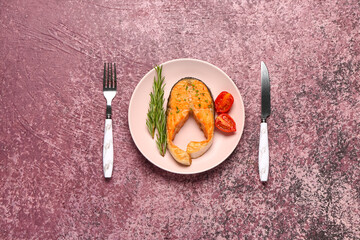 Plate of tasty salmon steak on purple background