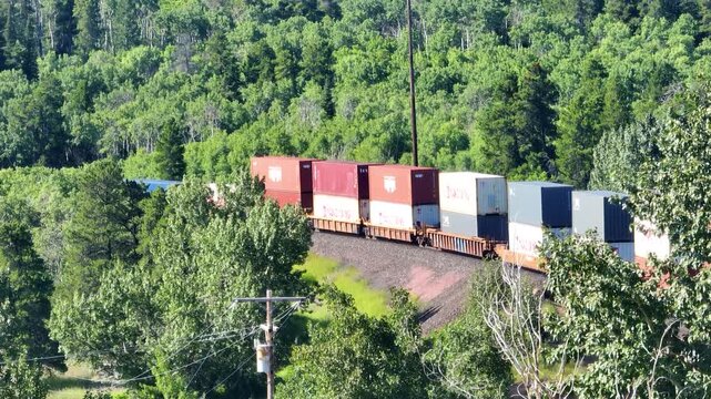 Aerial Freight Train in Dense Wyoming Forest Summer Glacier East
