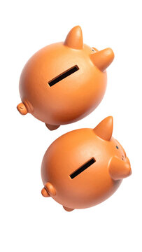 Two piggy banks stacked, orange color, angled view