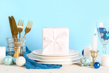 Decorated Christmas table setting on blue background