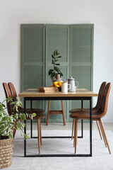Interior of room with dining table and folding screen