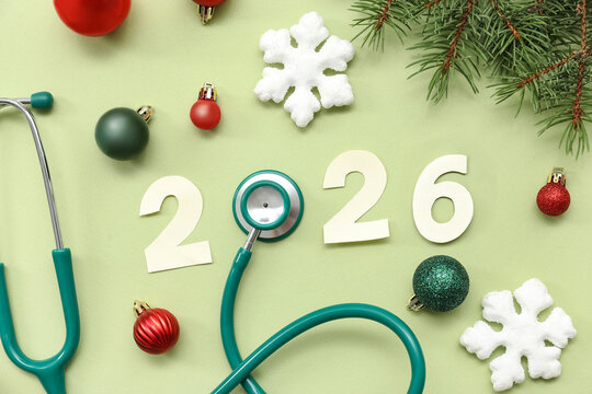 Composition with paper figure 2025, stethoscope and Christmas decorations on color background