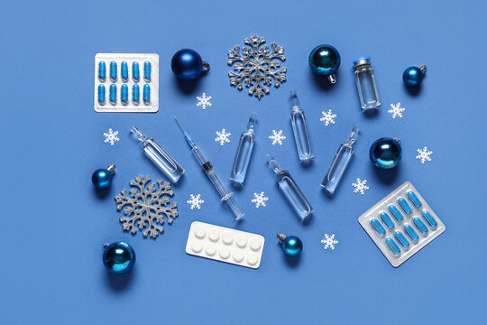 Composition with different medicines and Christmas decorations on blue background - Powered by Adobe