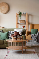 Interior of living room with sofa, table and cowboy hat