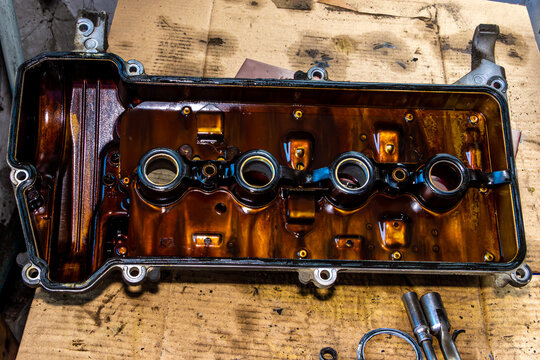 Poor oil circulation and infrequent changes cause sludge buildup under valve cover