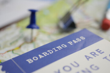Planning a trip with a boarding pass and map ready