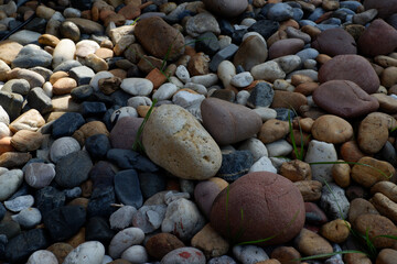 Peaceful pile of natural pebble and round stone. close up view of garden path with colorful rock texture, creating calm abstract background and serene wallpaper