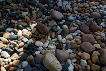 Natural colorful pebble, stone, and rock background texture. calm and peaceful smooth gravel surface showing detail of mineral floor pattern with earthy geology elements