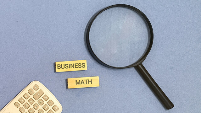 Magnifying Glass Over Business and Math Blocks with Calculator