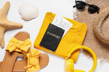 Composition with clothes, passport, tickets and accessories on white background, closeup