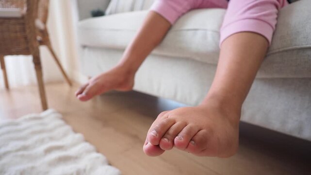 Feet dangling from the couch in a cozy living room
