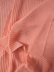 background and pattern of plain pink fabric with striped motif