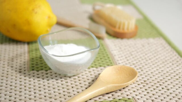 Making a natural lemon and baking soda on a rug for cleaning 
