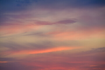 Moody sky at sunset in pastel blue, purple, pink, and yellow, as a nature background
