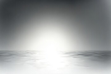 Minimal monochrome seascape with bright light on the horizon, soft rippled water and foggy sky conveying calm, serene and contemplative mood