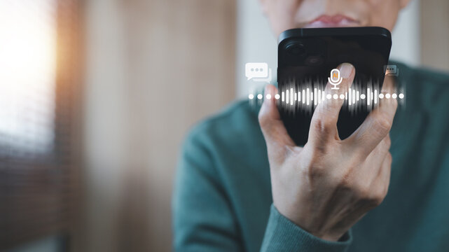 Person holding smartphone using voice command assistant with sound wave recognition. Concept of Artificial Intelligence, communication technology, digital assistant application, and modern technology. - Powered by Adobe