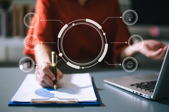 Businesswoman uses a tablet to analyze data on a virtual interface, symbolizing business innovation, technology, and global connection