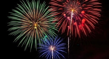 Vibrant display of three colorful fireworks exploding in the night sky, featuring bright green, red, and blue bursts creating a festive and celebratory atmosphere