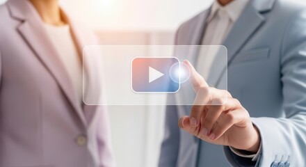 Business people interacting with a digital interface, possibly a video player icon, in a modern office setting, representing technology and professional collaboration