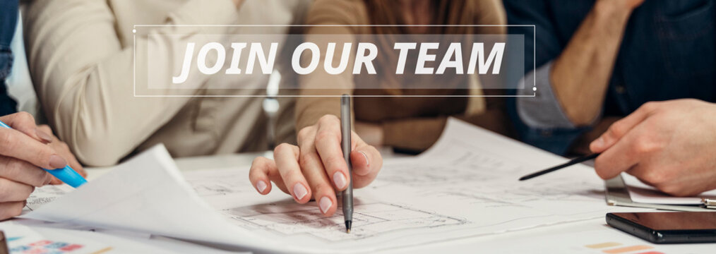 Join our team text banner over busy group of professionals reviewing project plans