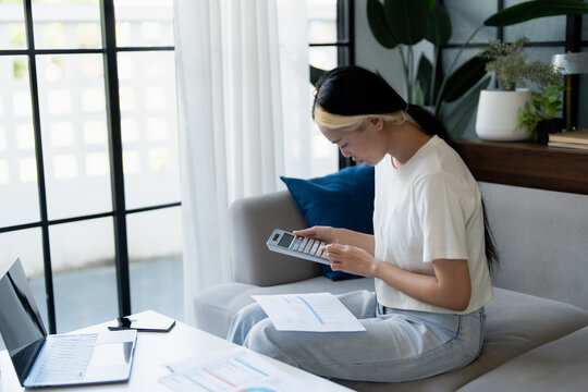 Asian Woman Managing Finances pay Bills and Budget financial at home.