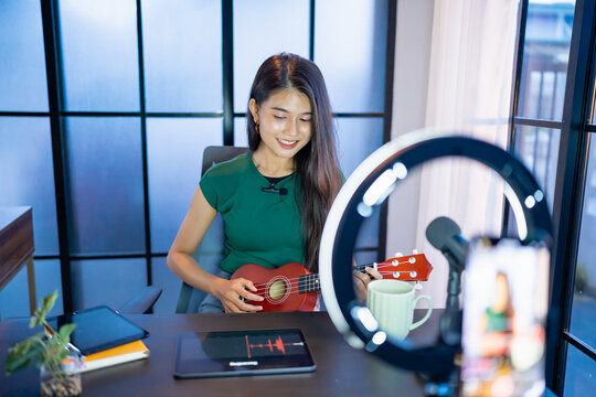 Content creator Young asian woman influencer creating content in home studio entertainment and communication blogger video record with smartphone for online vlog