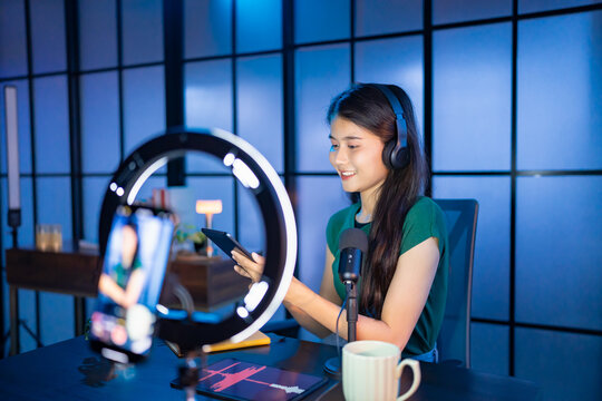 Content creator Young asian woman influencer creating content in home studio entertainment and communication blogger video record with smartphone for online vlog