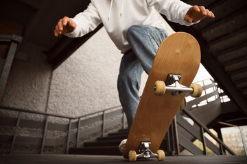 Young man with skateboard outdoors, closeup