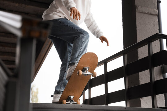 Young man with skateboard outdoors